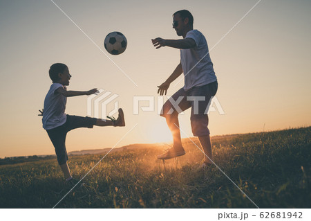 Father and young little boy playing in the field Father and young little boy playing in the field 62681942