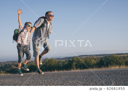 Father and son playing on the road at the day Father and son playing on the road at the day 62681950