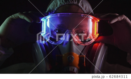 Man in protective costume suit, gas protect medical spray paint mask. Doctor in respirator. Concept health virus coronavirus epidemic. 62684311