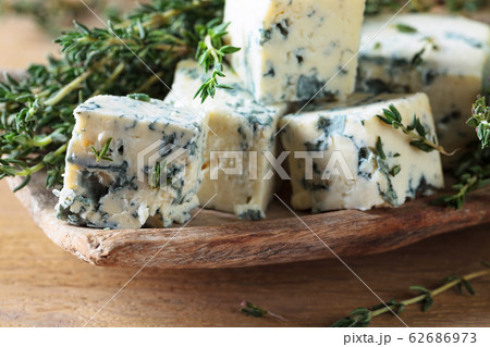 Pieces of blue cheese with thyme. Pieces of blue cheese with thyme. 62686973