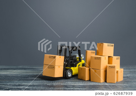 Yellow Forklift truck and cardboard boxes. Production, transport, cargo storage. Freight shipping. retail. Transportation logistics infrastructure, import and export goods and products delivery 62687939
