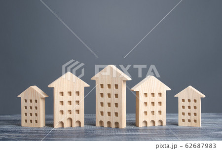 Row of wooden figures of residential buildings. Affordable comfortable housing. Search purchase best option apartment and real estate, rent and sale. Mortgage. Cozy ecological modern neighborhood. Row of wooden figures of residential buildings. Affordable comfortable housing. Search purchase best option apartment and real estate, rent and sale. Mortgage. Cozy ecological modern neighborhood. 62687983