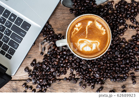 Latte art coffee cup and coffee bean with laptop 62689923
