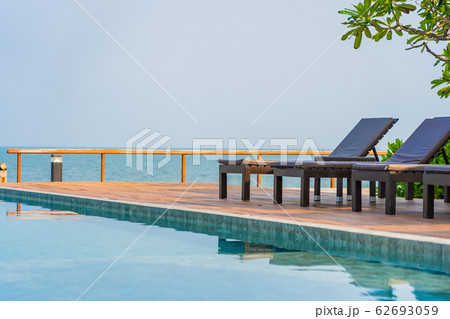 Beautiful empty chair umbrella around outdoor swimming pool in hotel resort for travel Beautiful empty chair umbrella around outdoor swimming pool in hotel resort for travel 62693059