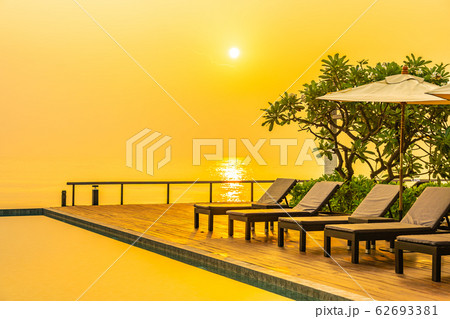 Beautiful sunrise around with umbrella and chair outdoor swimming pool Beautiful sunrise around with umbrella and chair outdoor swimming pool 62693381