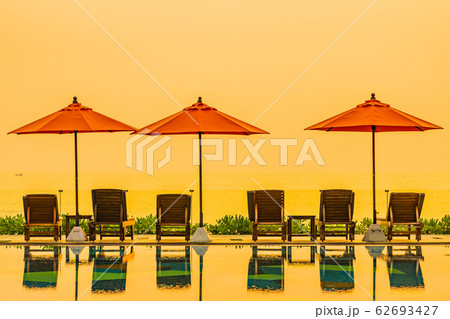 Beautiful sunrise around with umbrella and chair outdoor swimming pool Beautiful sunrise around with umbrella and chair outdoor swimming pool 62693427