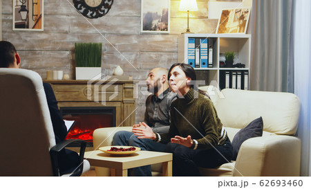 Angry wife on sofa at couple therapy yelling 62693460