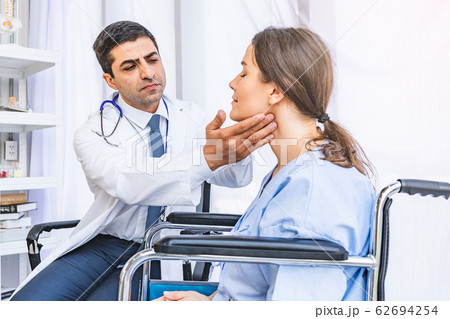 Asian doctor check-up pretty patient for her Thyroid hormones healthy at hospital or medical clinic 62694254