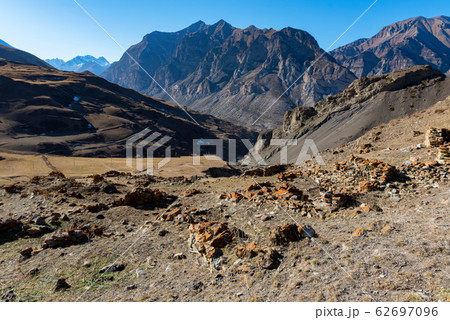 Distant view stone remains of old abandoned balkar village in North Caucasus 62697096