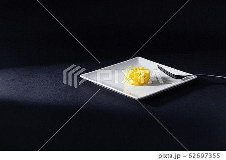 Stainless fork and tagliatelle pasta on the white 62697355