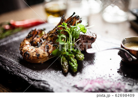 Tasting menu. Beef steak and grilled tiger prawns. Tasting menu. Beef steak and grilled tiger prawns. 62698409