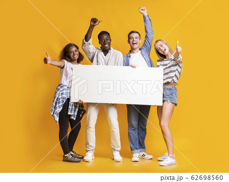 Cheerful international students with white empty board 62698560