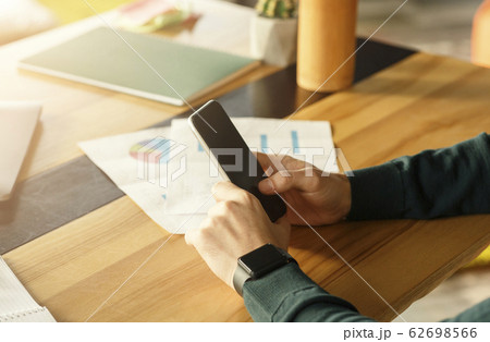 Guy Using Mobile Phone Sitting At Desk In Office, Cropped Guy Using Mobile Phone Sitting At Desk In Office, Cropped 62698566