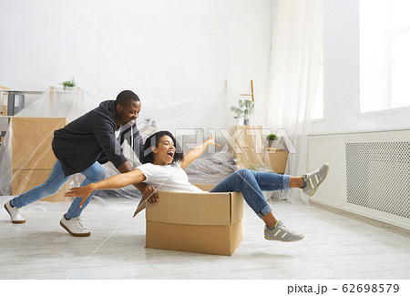Start repair in apartment. Husband rolling wife in box Start repair in apartment. Husband rolling wife in box 62698579