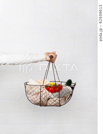 Woman keeps backet with fresh vegetables and fuits 62698613