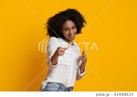 Gotcha. Positive african american woman pointing her index fingers at camera Gotcha. Positive african american woman pointing her index fingers at camera 62698635