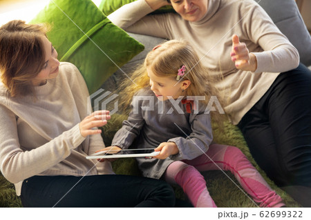Happy loving family. Grandmother, mother and daughter spending time together Happy loving family. Grandmother, mother and daughter spending time together 62699322