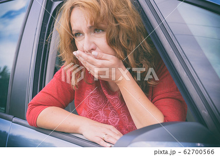 Woman suffering from motion sickness Woman suffering from motion sickness 62700566