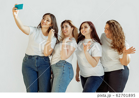Young women in casual clothes having fun together. Bodypositive concept. Young women in casual clothes having fun together. Bodypositive concept. 62701895