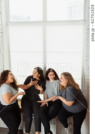 Young women in casual clothes having fun together. Bodypositive concept. Young women in casual clothes having fun together. Bodypositive concept. 62701928