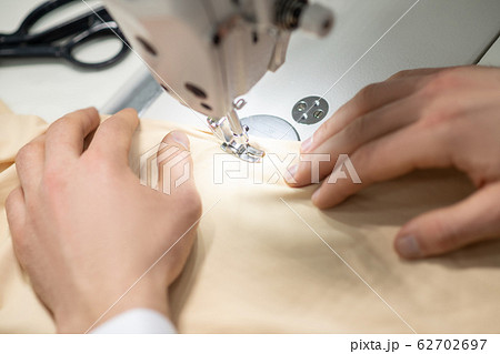 Hands of male tailor on sewing machine Hands of male tailor on sewing machine 62702697