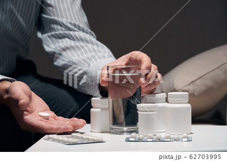 Overworked businessman sitting on the sofa and 62703995