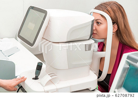Measuring young woman's eye pressure with tonometer 62708792