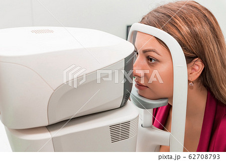 Measuring young woman's eye pressure with tonometer Measuring young woman's eye pressure with tonometer 62708793