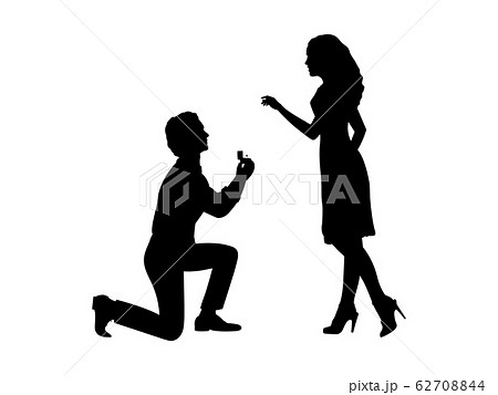 Silhouette of man standing on knee makes an offer to marry woman 62708844