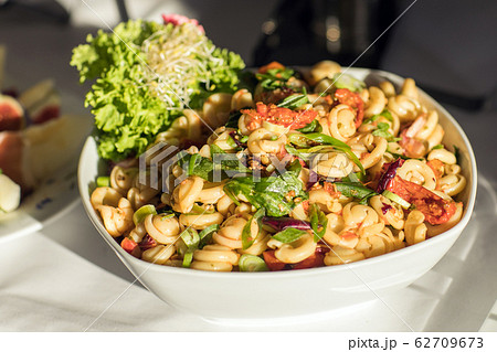 Pasta with fresh vegetables on white plate Pasta with fresh vegetables on white plate 62709673