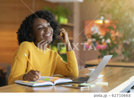 Young afro woman dreaming about successful career Young afro woman dreaming about successful career 62710668