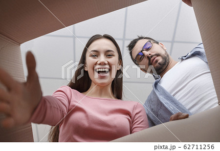 Woman and man are looking into box Woman and man are looking into box 62711256