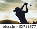Silhouette of  young professional female golf player hit sweeping and keep golf course doing golf swing,she does exercise for relax time 62711677
