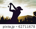 Silhouette of  young professional female golf player hit sweeping and keep golf course doing golf swing,she does exercise for relax time 62711678