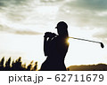 Silhouette of  young professional female golf player hit sweeping and keep golf course doing golf swing,she does exercise for relax time 62711679