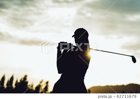 Silhouette of young professional female golf player hit sweeping and keep golf course doing golf swing,she does exercise for relax time Silhouette of young professional female golf player hit sweeping and keep golf course doing golf swing,she does exercise for relax time 62711679