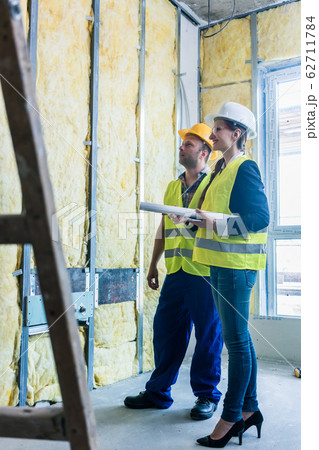 Construction manager and architect checking the insulation works Construction manager and architect checking the insulation works 62711784