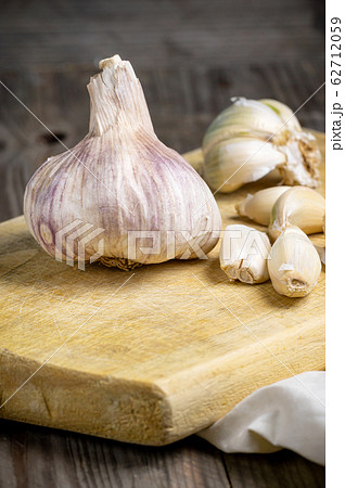 Vintage still life with garlic on wooden table. Vintage still life with garlic on wooden table. 62712059