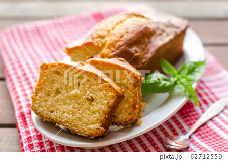 Lemon pound cake on rustic wooden background with lemon. Lemon pound cake on rustic wooden background with lemon. 62712559