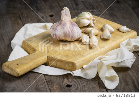 Still life with garlics on rustic wood table. Still life with garlics on rustic wood table. 62713813