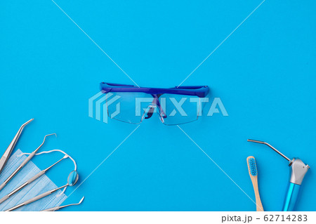 Dentist tools over blue background top view 62714283