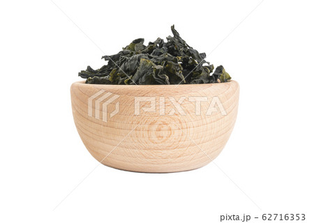 Dried kombu seaweed in wooden bowl isolated 62716353