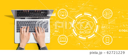 Backup concept with person using laptop computer Backup concept with person using laptop computer 62721229