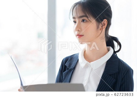 A business woman beside the window A business woman beside the window 62723633