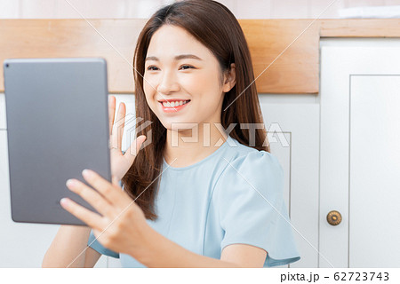 A beauty woman using tablet in the kitchen A beauty woman using tablet in the kitchen 62723743