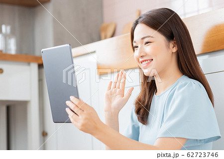 A beauty woman using tablet in the kitchen A beauty woman using tablet in the kitchen 62723746