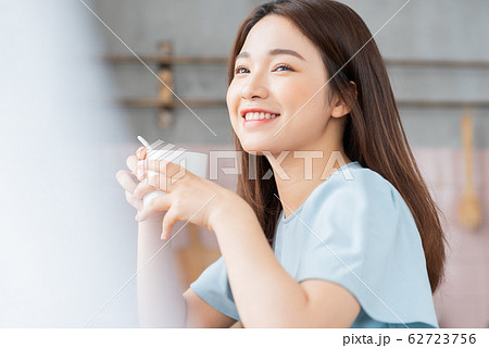 A beauty woman drink coffee by the window in the morning A beauty woman drink coffee by the window in the morning 62723756