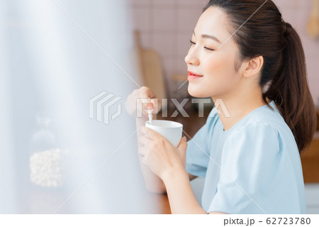 A beauty woman drink coffee by the window 62723780