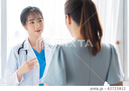 a woman doctor talking with her patient a woman doctor talking with her patient 62723812