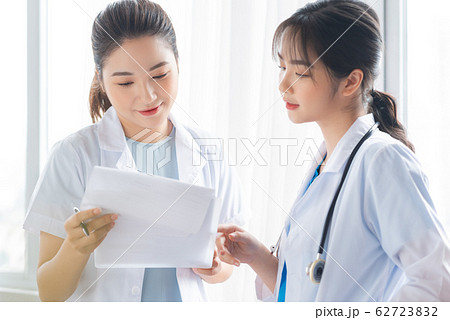 Two women doctor consulting by the window 62723832